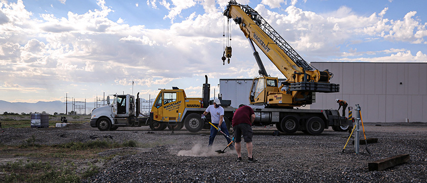 DAQ staff prepping the site for a new air quality monitor at the Utah State Prison.