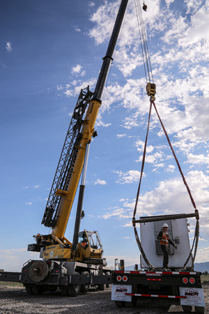 Picture of a crane lifting a new air quality monitor into place.