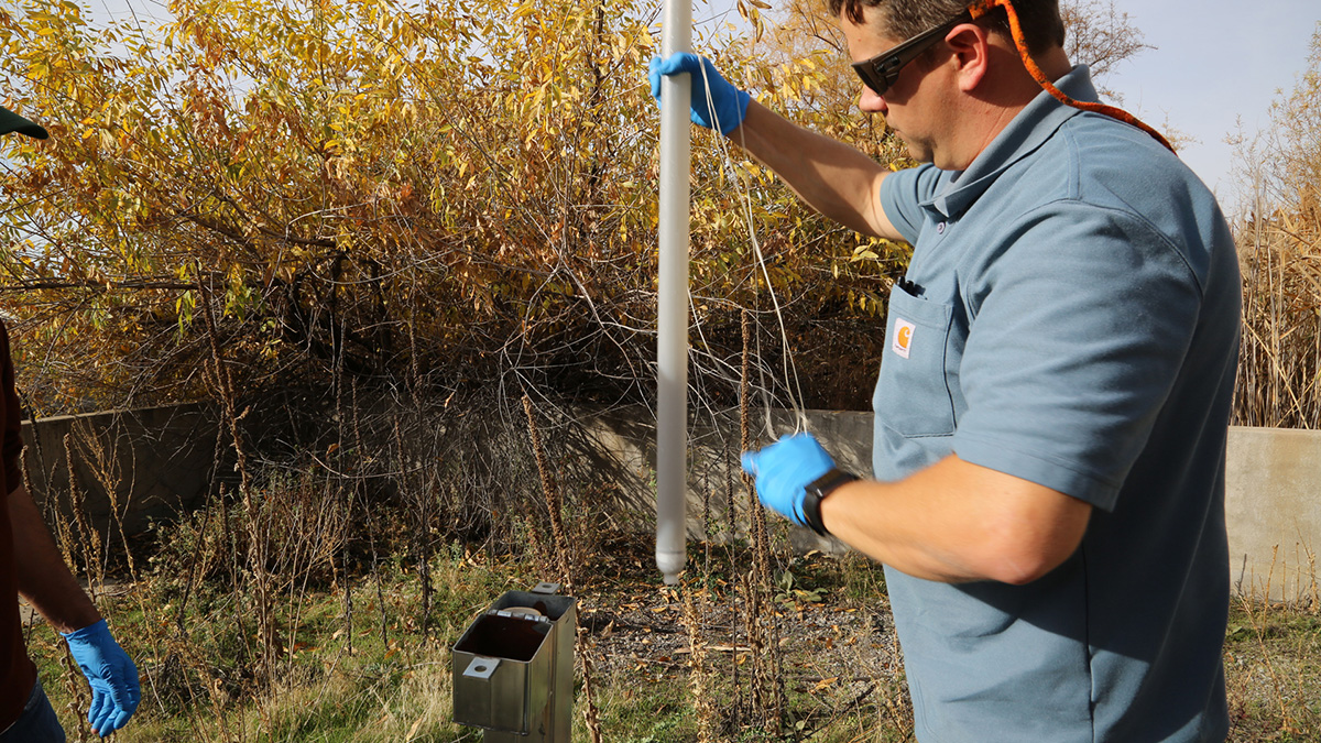 Chris Martin checks a groundwater monitor