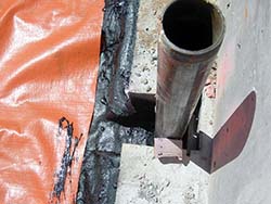 View (looking down) of a completed vent line connected to the venting conduit under the vapor barrier.