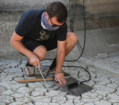 A Water Quality scientist installing an automatic pump in a canal at the Utah Inland Port.