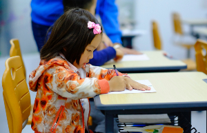 Girl working at a school desk