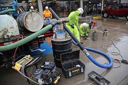 Division of Environmental Response and Remediation (DERR) environmental scientist Kevin Beery oversees the installation of Geoprobes to test groundwater near the gas station.